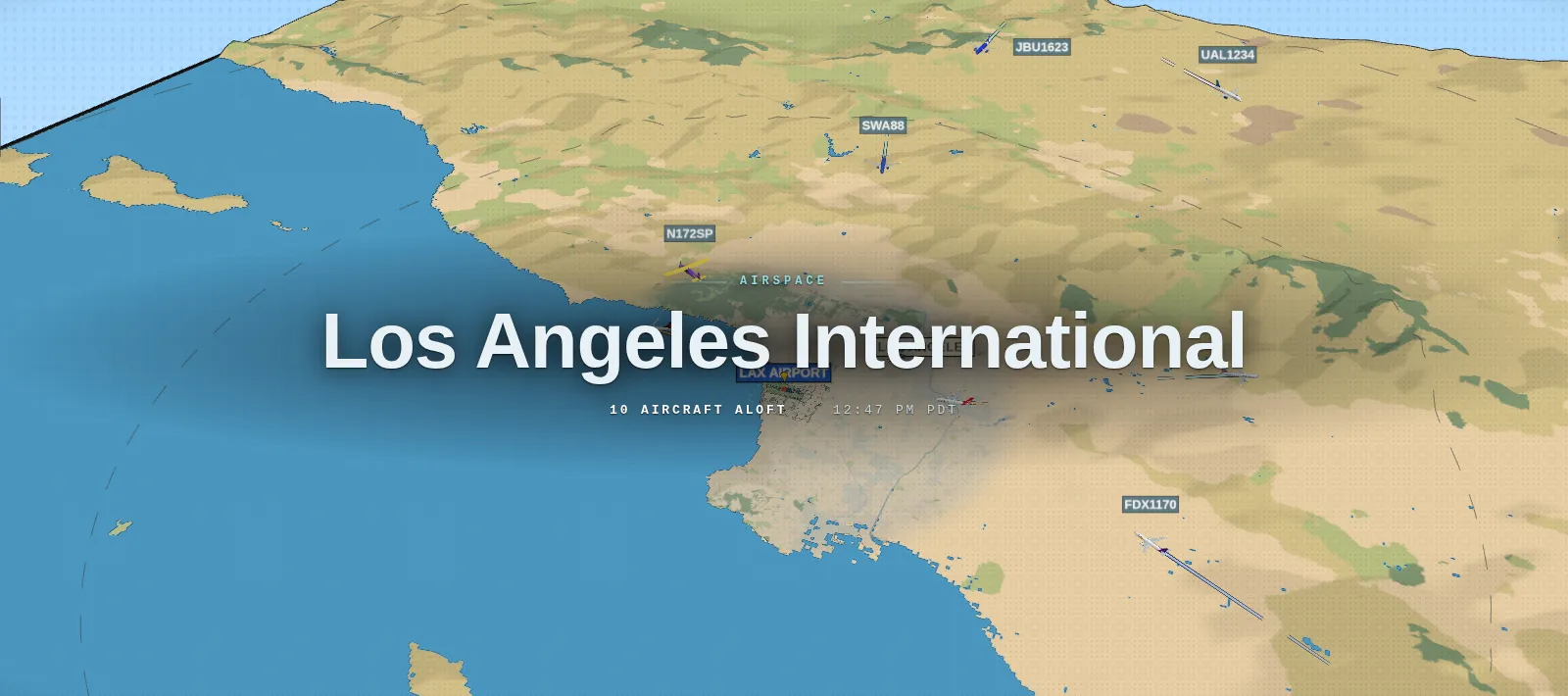 Airliners over the hills around Los Angeles, their contrails tinted by altitude.